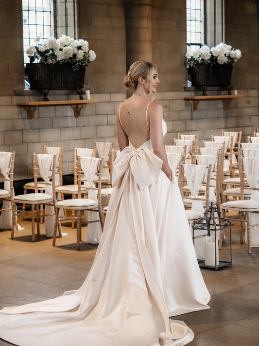 Embrace elegance with the Rachel Rose Bridal Dove Empire Wedding Dress