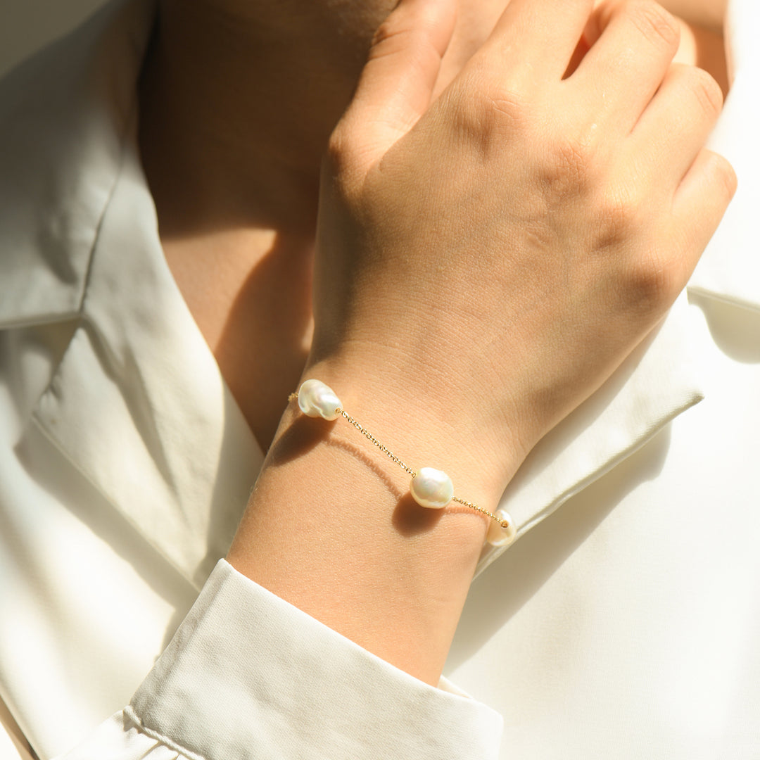 Adorn your wrist with the allure of five lustrous pearls on a delicate 14k Solid Gold chain