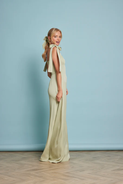 Side Profile of Model Wearing Allegra Sage Green Wedding Guest Dress