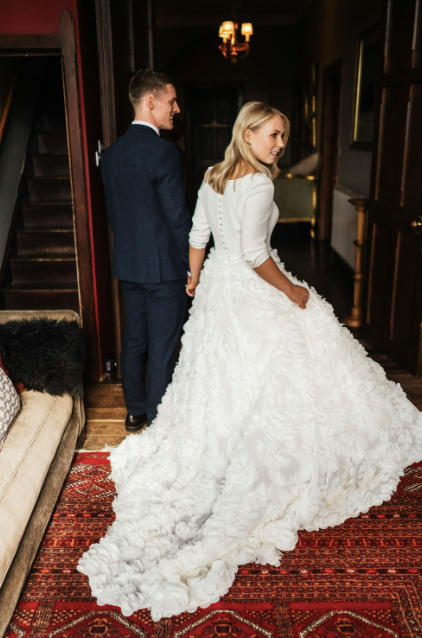 A side and back view of the Darcy Tara Long Sleeve Wedding Gown