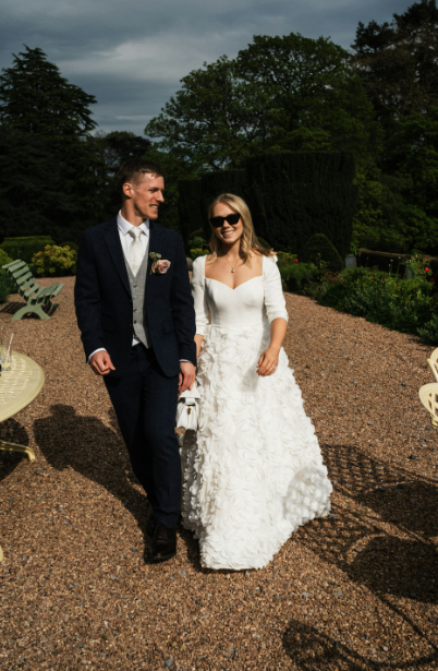 Turn heads in this elegant Sassi Holford Long Sleeve Wedding Gown