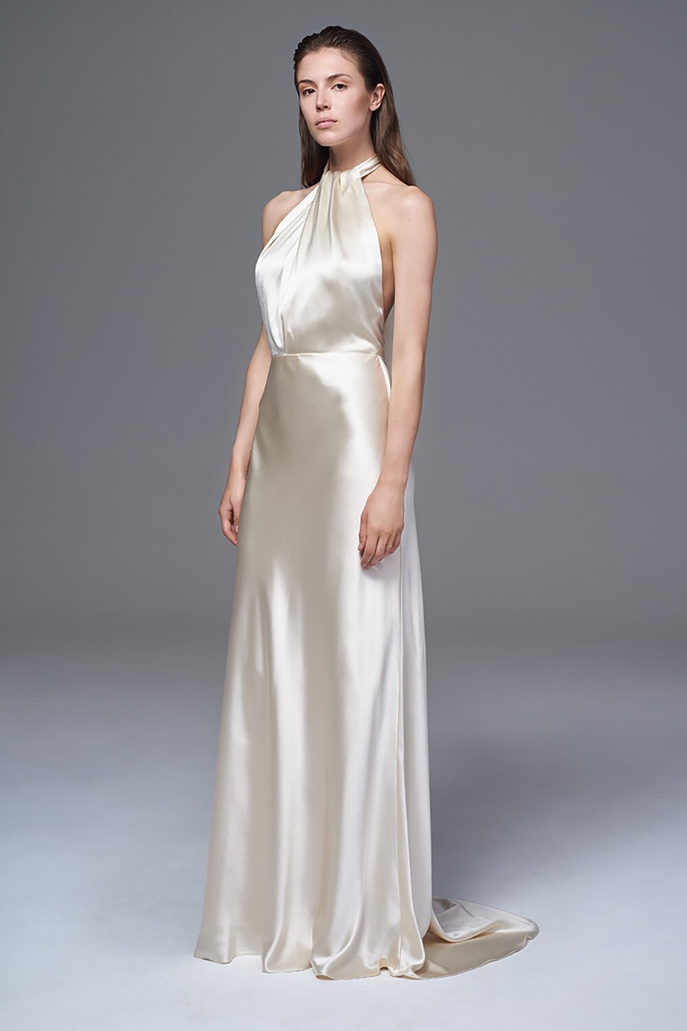 This stunning silk wedding dress boasts a stunning halter neckline